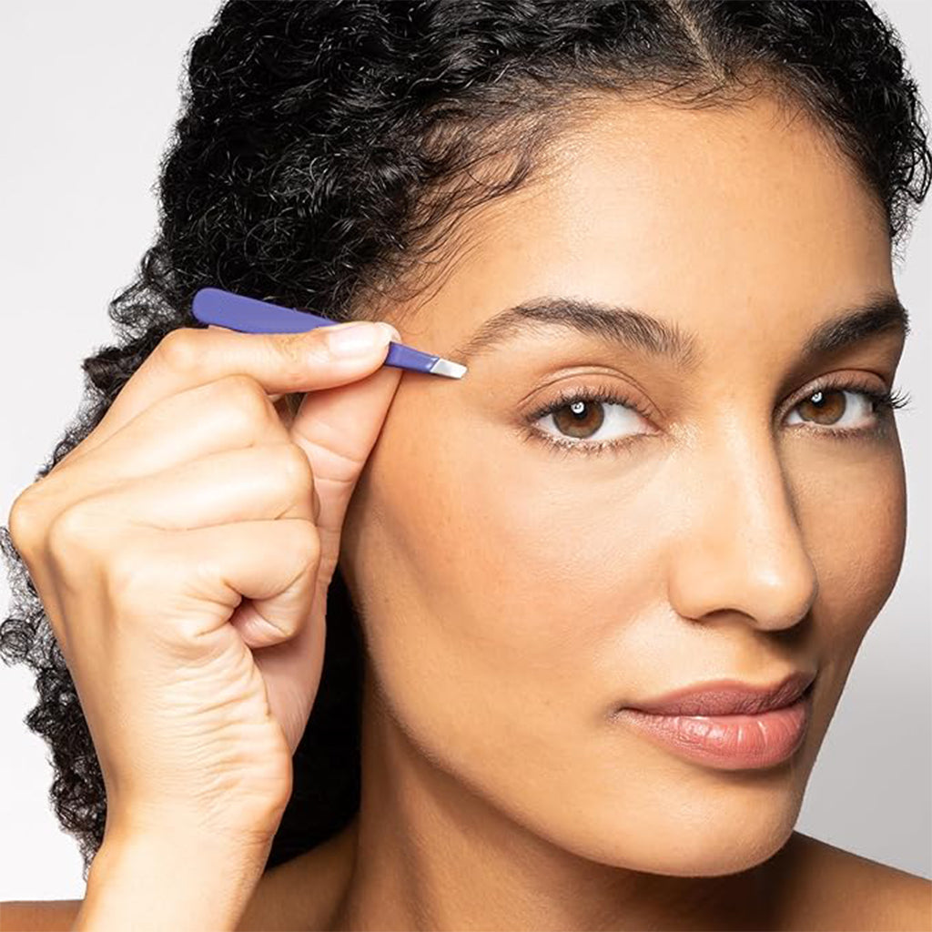 Aardlig Precision Tweezer in use for precise eyebrow grooming and hair removal by a woman.